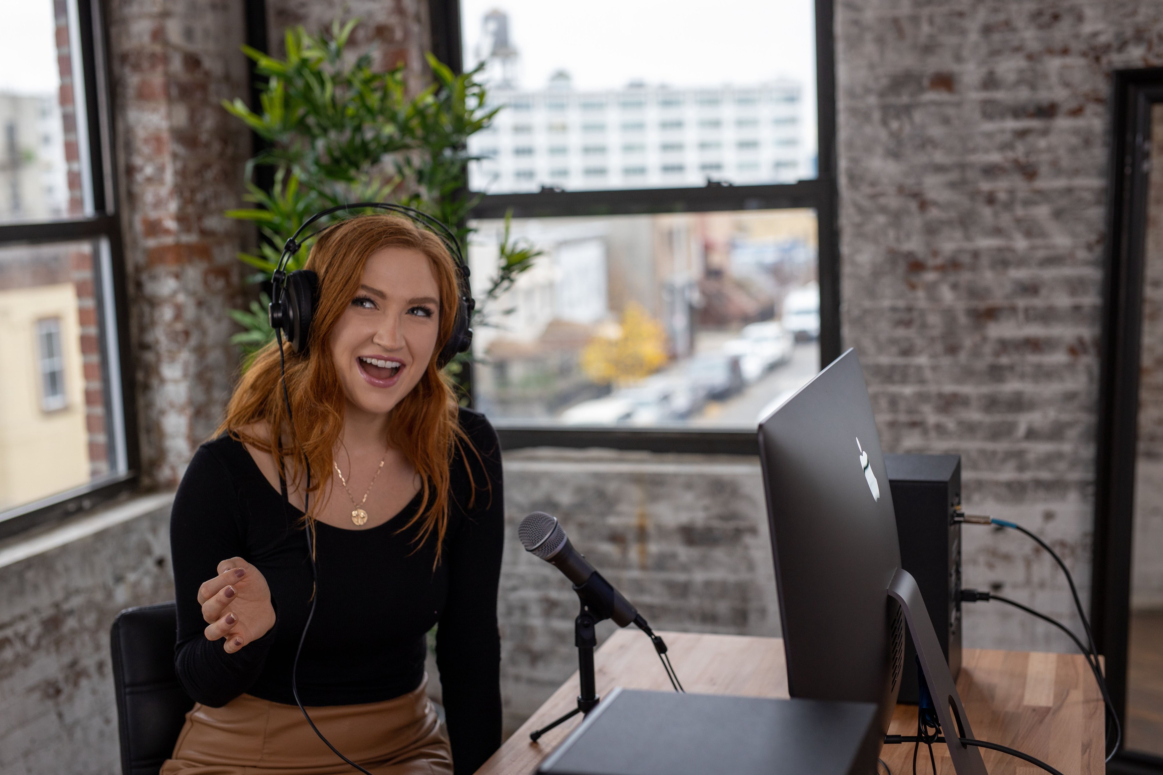 Woman with Q2U mic recording a podcast